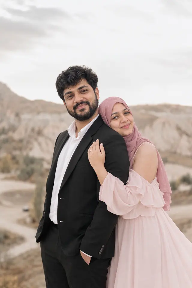 Smiling over his shoulder: a couple photographed at Fairy-chimney valley, Turkey