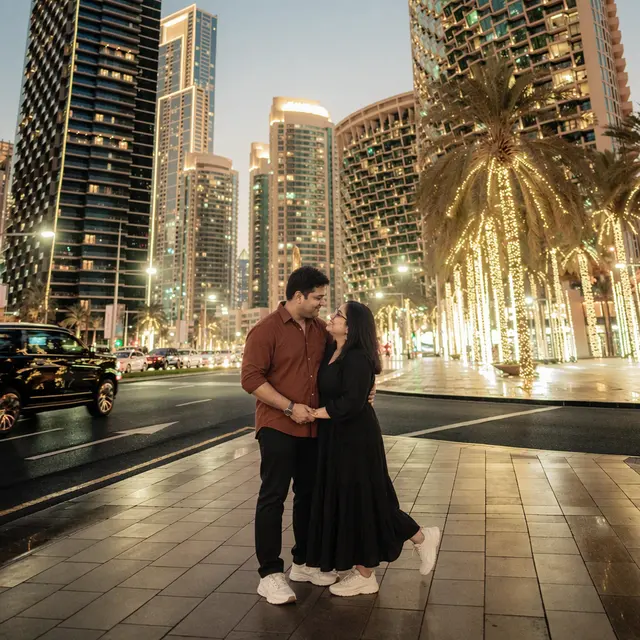 City lights embrace: a couple photographed at Dubai Marina, Dubai