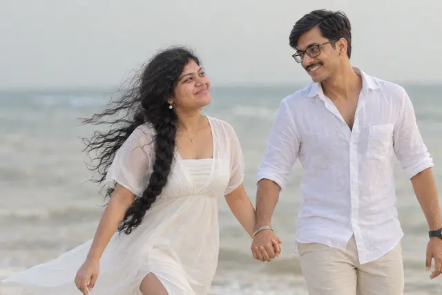 Running along the shore: a couple photographed at The beach, Goa