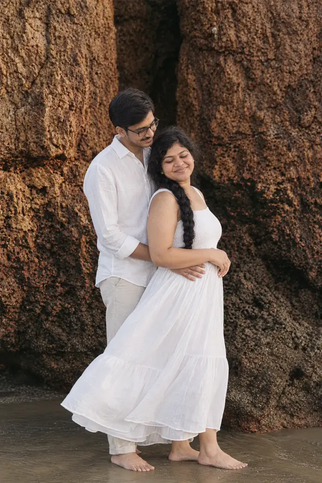 Embrace by the rocks: a couple photographed at The beach, Goa