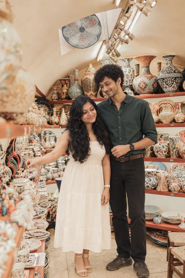 Choosing painted ceramics: a couple photographed at Grand Bazaar, Turkey