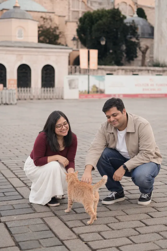 Petting a street cat: a couple photographed at Old town, Turkey
