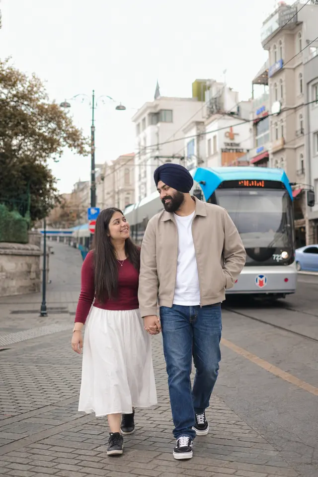 Walking with the tram: a couple photographed at Old town, Turkey