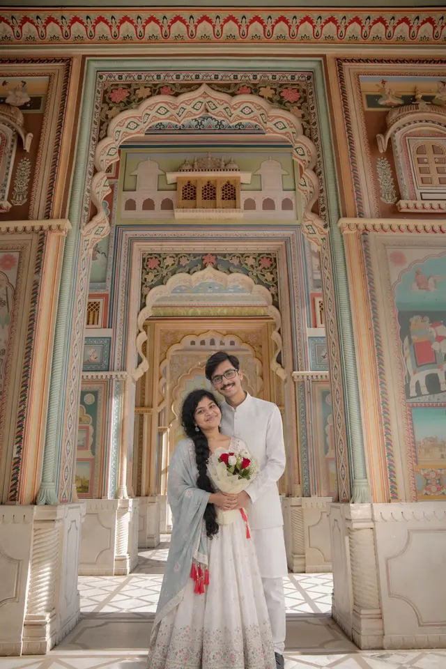 Together under arches: a couple photographed at Patrika Gate, Jaipur