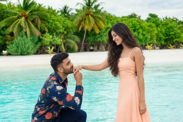 On one knee by the lagoon: a couple photographed at White-sand beach, Maldives