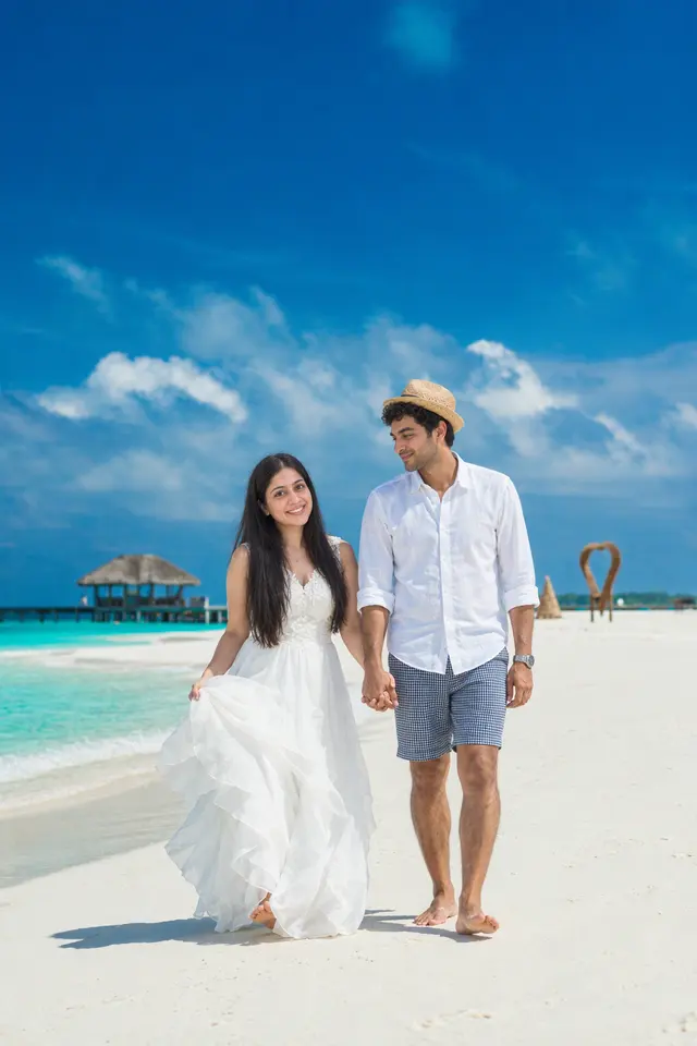 Walking hand in hand: a couple photographed at White-sand beach, Maldives
