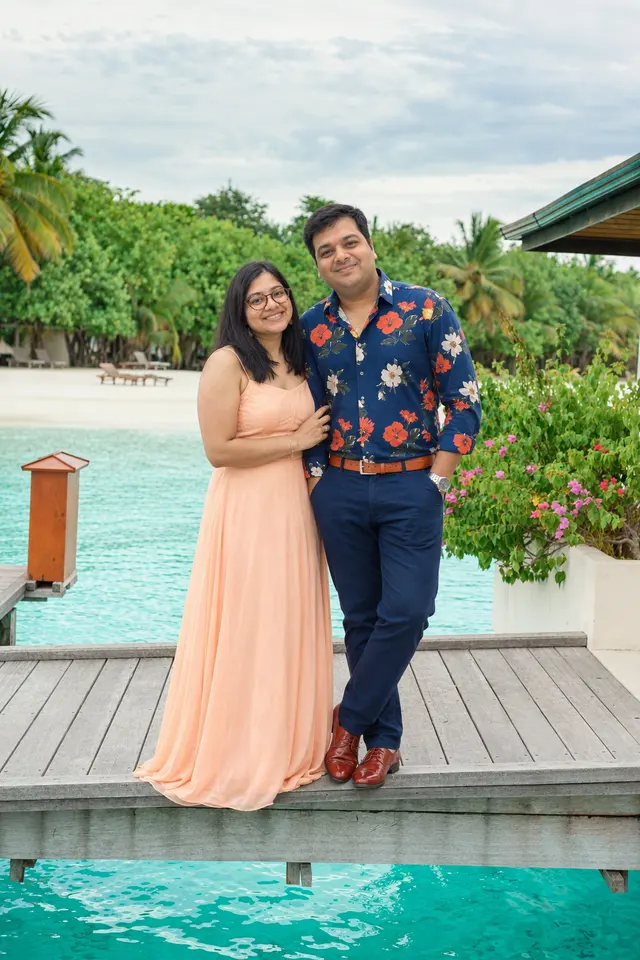 Standing by the water: a couple photographed at Overwater jetty, Maldives