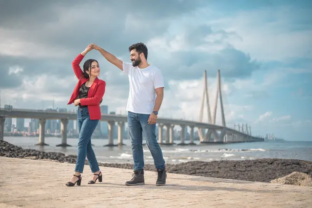 A twirl with the Sea Link behind: a couple photographed at Bandstand, Mumbai