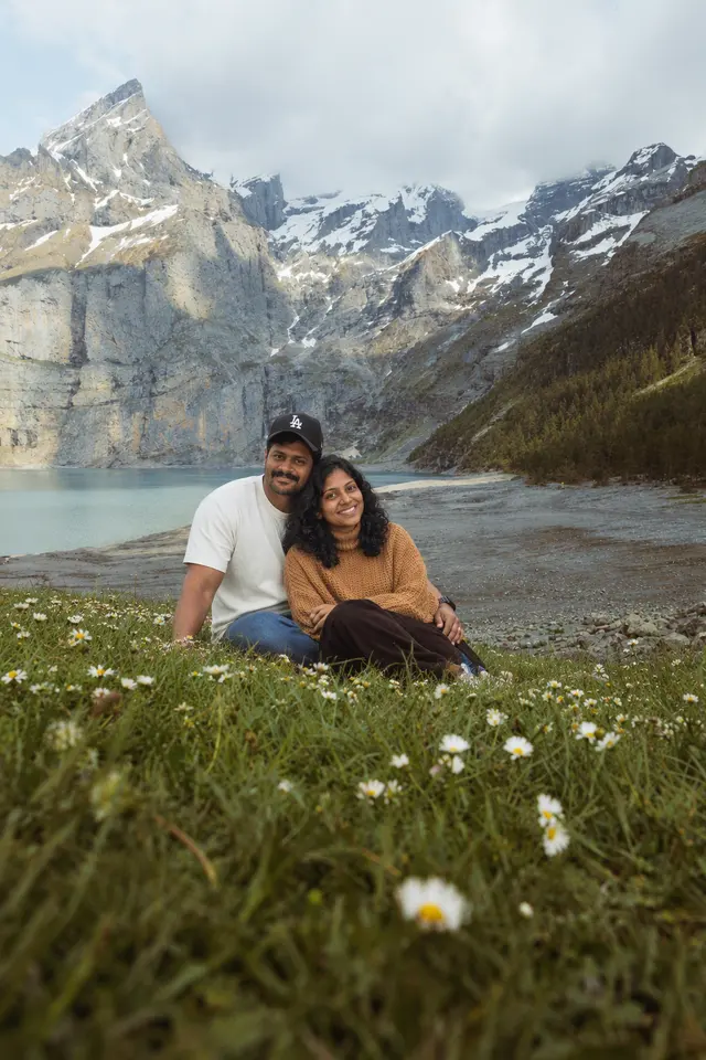 Cuddling by the lake: a couple photographed at An alpine lake, Switzerland