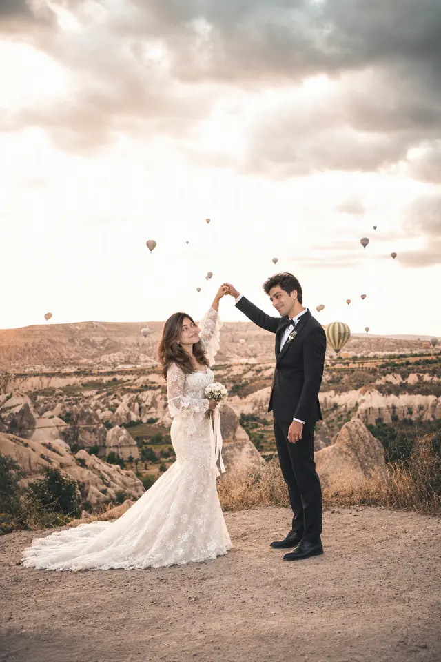 A twirl above the valley: a couple photographed at Hot-air balloons, Turkey