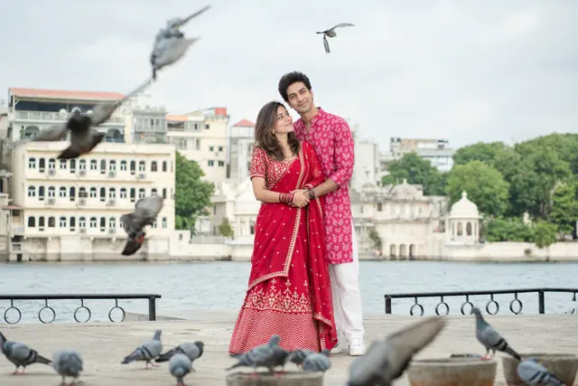 Red lehenga at the ghat: a couple photographed at Gangaur Ghat, Udaipur