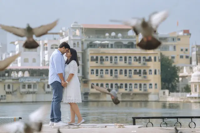 Pigeons take flight: a couple photographed at Gangaur Ghat, Udaipur